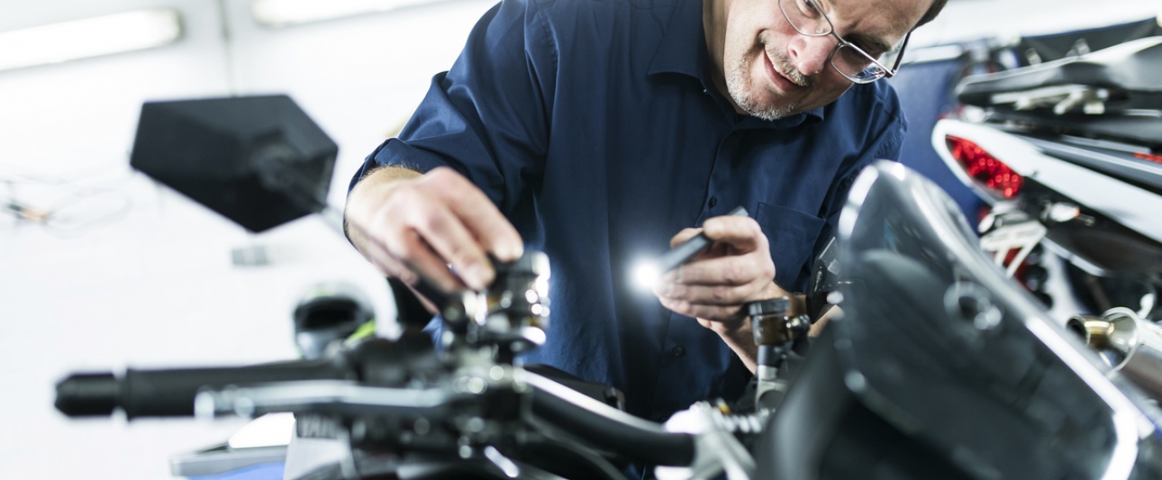 Ein Mann untersucht ein Motorrad